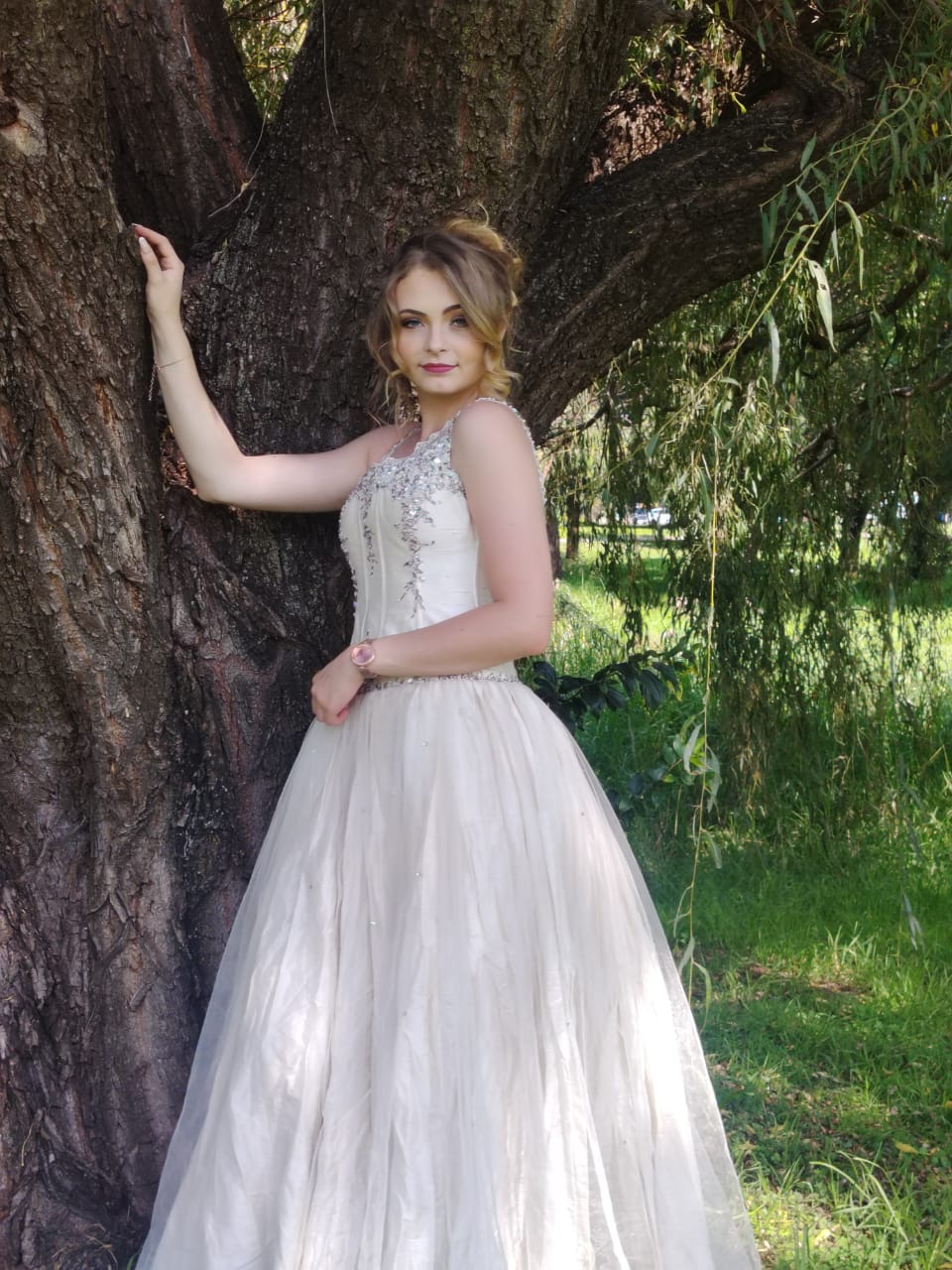 Cedar Hair & Makeup bride in a full-length wedding gown with styled hair and makeup