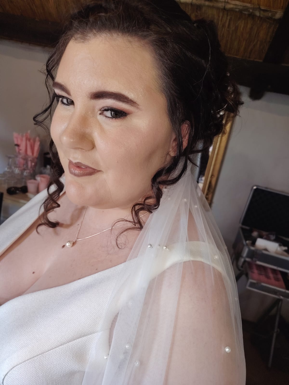 Bridal side profile with veil placed into a soft styled finish by Cedar in Vereeniging